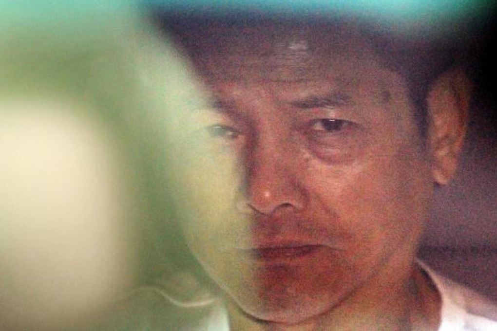 "Broken Tooth" Wan Kuok-koi leaves Coloane Prison in the back of a car yesterday with a glare for the media pack. Photo: Edward Wong