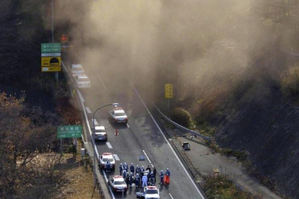 Smoke billows from the Sasago tunnel in Koshu city, Yamanashi prefecture, as emergency crews plan the rescue operation. Photo: AFP
