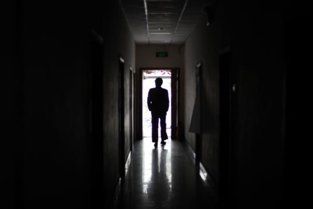 A 2009 file photo of a man standing in the corridor of a former 'black jail' in Beijing, China. Photo: AP