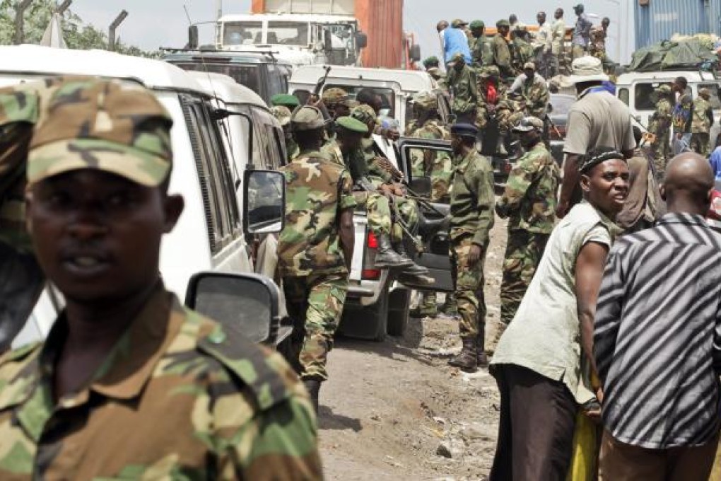 A traffic jam is caused by trucks carrying the M23 rebel fighters out of the city of Goma on Saturday. Photo: EPA