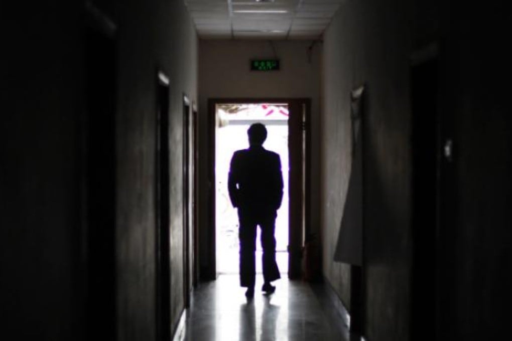 A man walks through a former black jail, part of a large-scale system of secret detention centres in Beijing where dissidents are held to prevent them from lodging formal complaints with the central government. Photo: AP