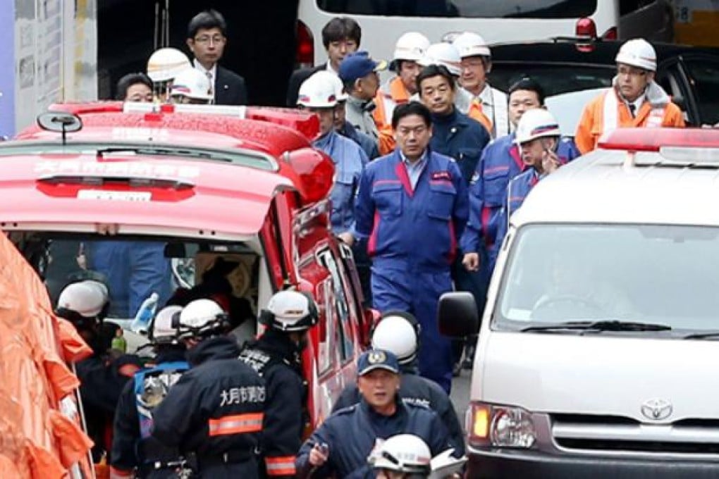 Japanese Transport Minister Yuichiro Hata (centre) inspects the scene at the Sasago tunnel road a wall collapsed near Otsuki, 80km west of Tokyo. Photo: AFP