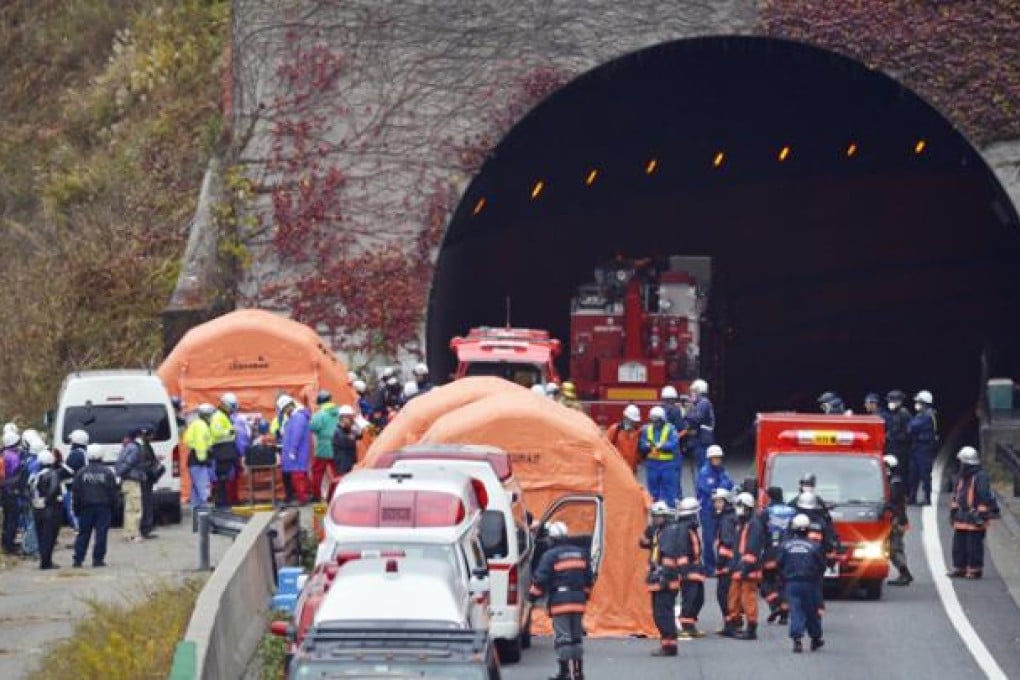 Fire fighters and rescue personnel are seen at the entrance of the Sasago tunnel, about 80km west of Tokyo, in Otsuki, Yamanashi Prefecture, on Monday. Photo: EPA