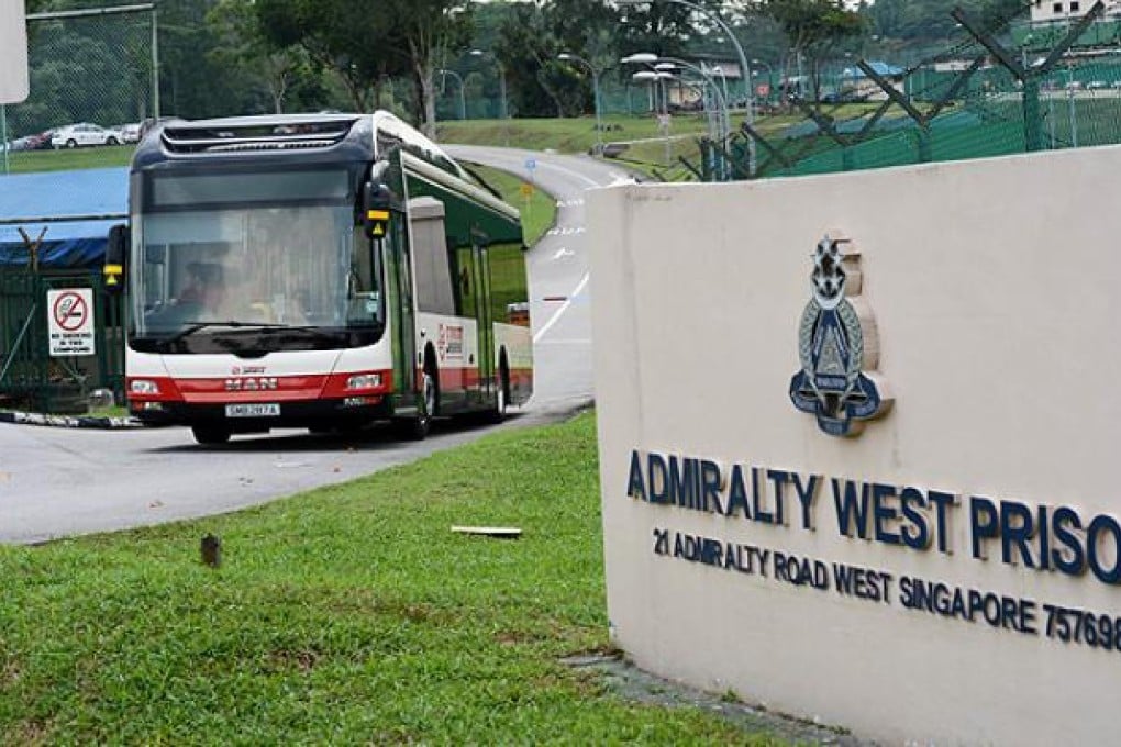 A bus brings Chinese bus drivers to Admiralty West prison in Singapore. Photo: AP