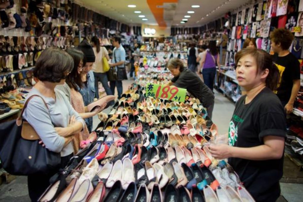 Shoppers browse shoes in a store at the Shilin market in Taipei. Photo: Bloomberg