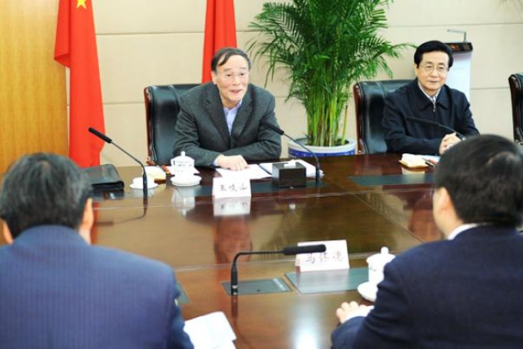 Wang Qishan (centre) speaks at a seminar held to solicit suggestions from the legal academic circle on enhancing supervision of cadres to prevent corruption and improving the party's working style in Beijing on Friday. Photo: Xinhua