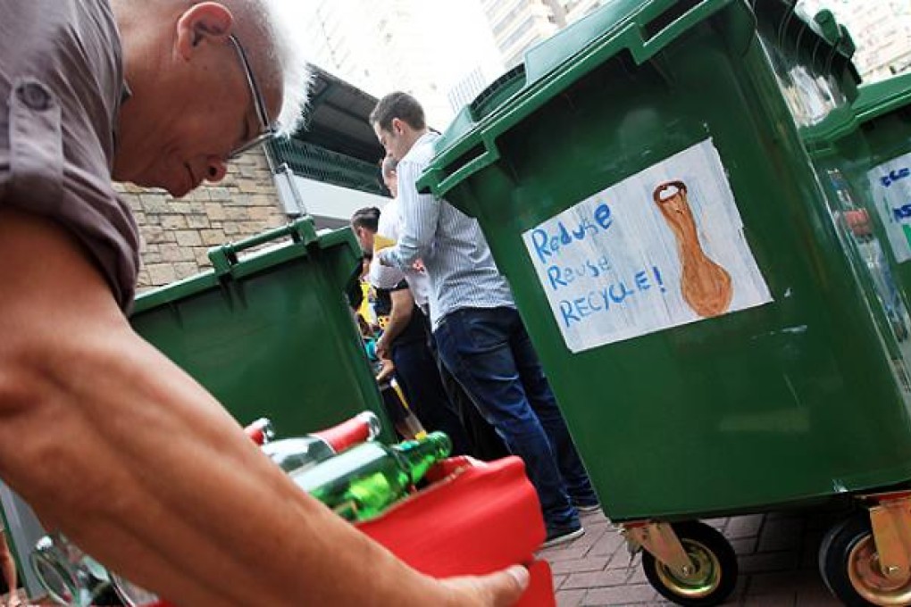 People recycle bottles in Wan Chai. Photo: Jonathon Wong