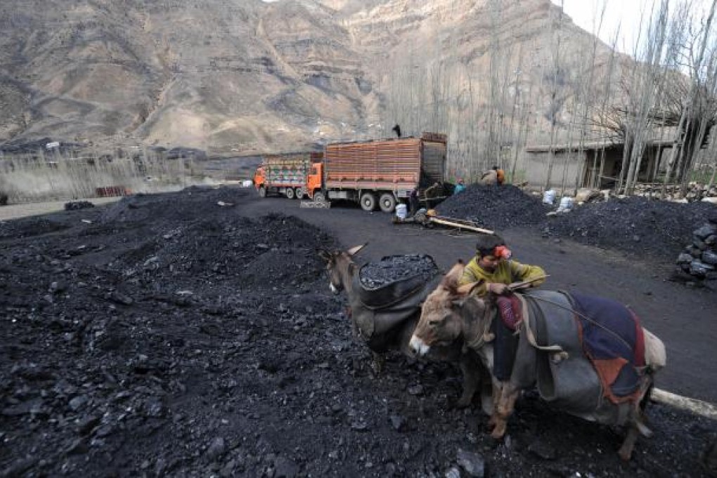 A miner unloads coal from donkeys at a mine north of Kabul. Photo: AFP