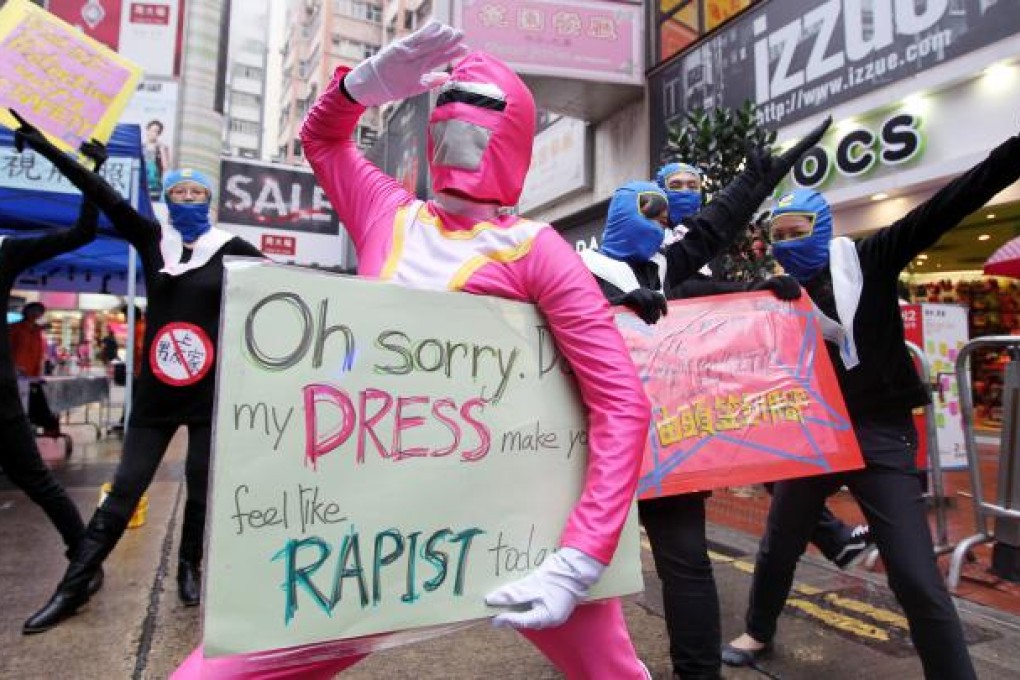 SlutWalk participants display protest signs. Photo: Nora Tam