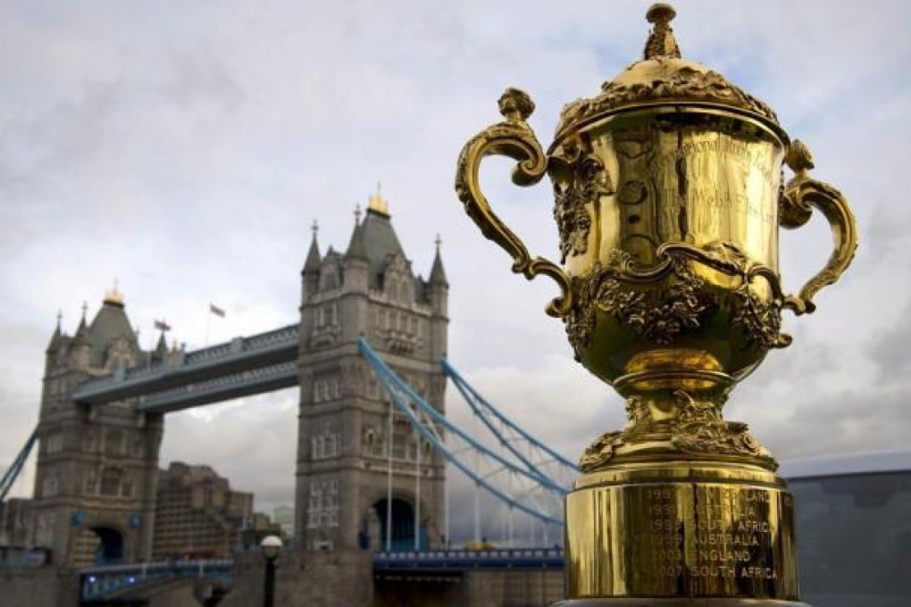The Webb Ellis Cup near Tower Bridge ahead of the Rugby World Cup draw. Photo: AFP