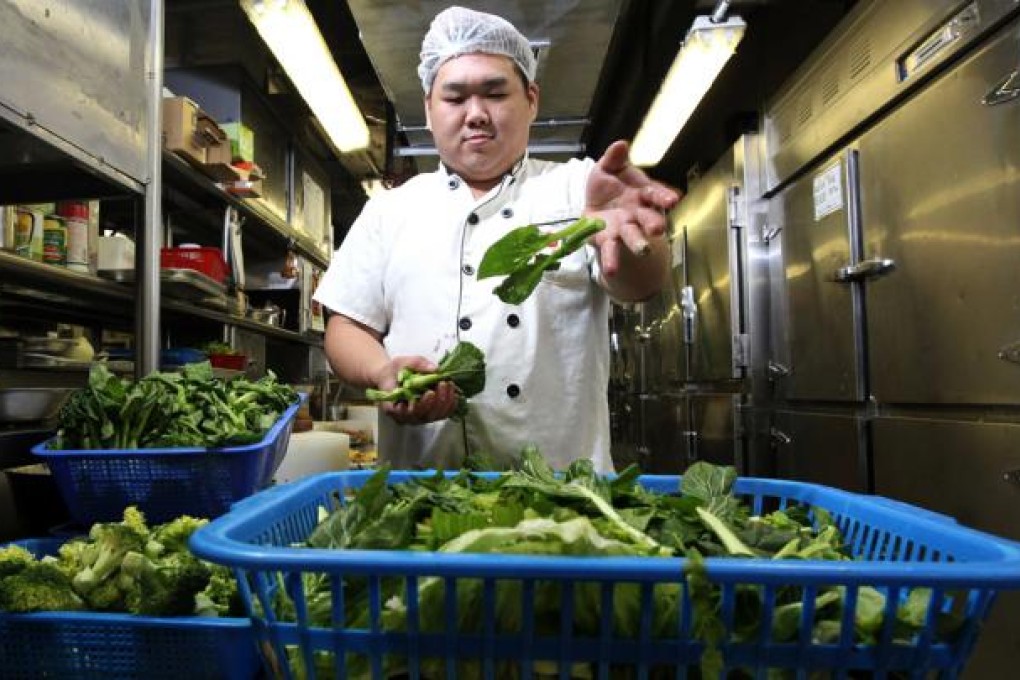Chan Yi-chun, from Choi Fook Restaurant, discards kitchen waste. Photo: Dickson Lee