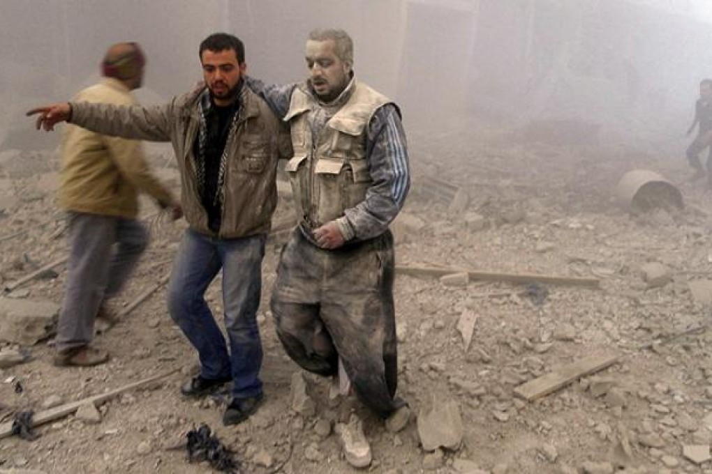Rebel fighters emerge from buildings hitd by Syrian Air Force fighters in Akraba, Damascus. Photo: Reuters