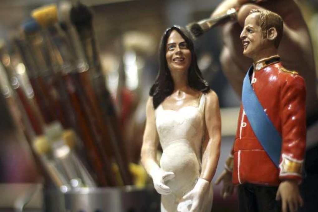 Figurines of Prince William and his wife Catherine being painted in a shop in Naples. Photo: Reuters
