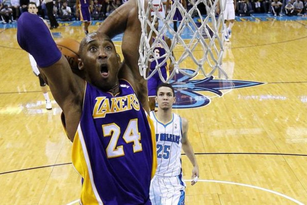 Kobe Bryant prepares to dunk in a game where he passed 30,000 points for his career. Photo: Reuters
