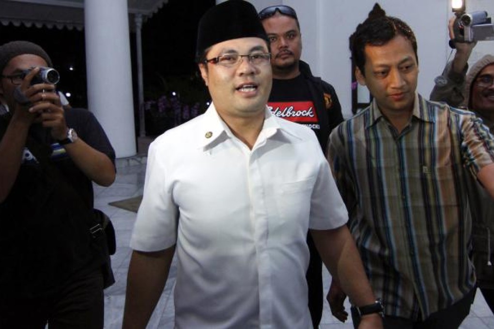 Garut District Chief Aceng Fikri is surrounded by the press. Photo: AP