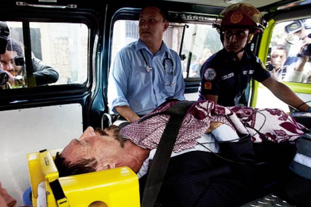 John McAfee lies in an ambulance, to be transferred from an immigration detention centre to a hospital, in Guatemala City on Thursday. Photo: AP