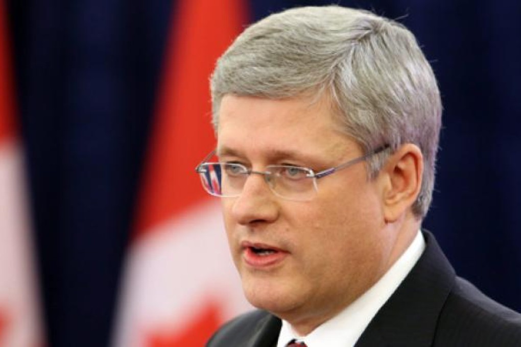 Canadian Prime Minister Stephen Harper announces his governrment's approval of the takeover of the Canadian oil-sands firm Nexen by China's state-owned oil and gas producer CNOOC on Friday. Photo: AP