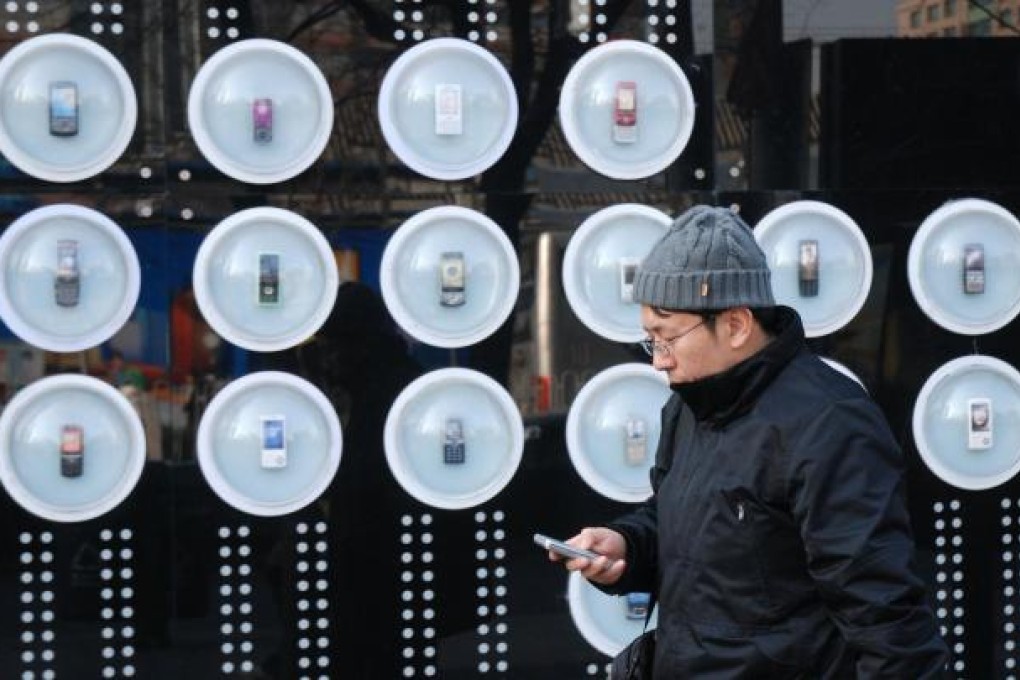 Mobile-phone outlets like this one in Beijing now offer internet-enabled smartphones, with alternatives to SMS. Photo: AFP