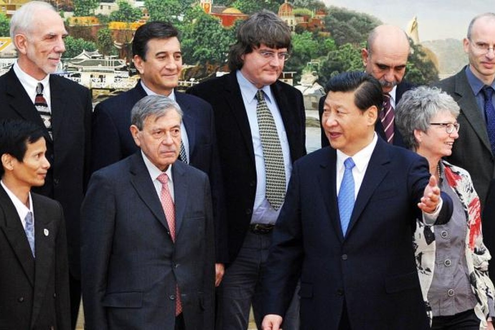 Communist Party leader, Xi Jinping, gestures as he chats to foreign experts working in China during a Beijing meeting. Photo: Xinhua