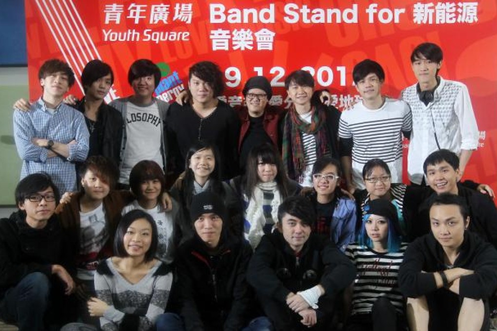 Joey Ou Sun-ming (fourth from right, rear row) helps local bands teach young people how to play rock instruments. Photo: Edward Wong