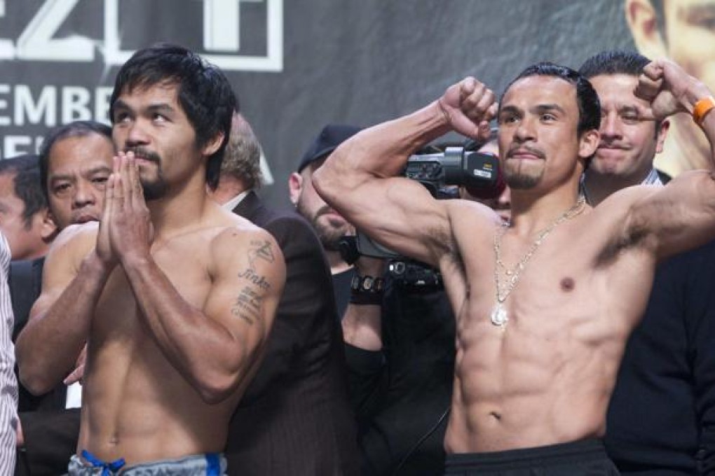Filipino boxer Manny Pacquiao (left) and Juan Manuel Marquez (right) of Mexico. Photo: Reuters