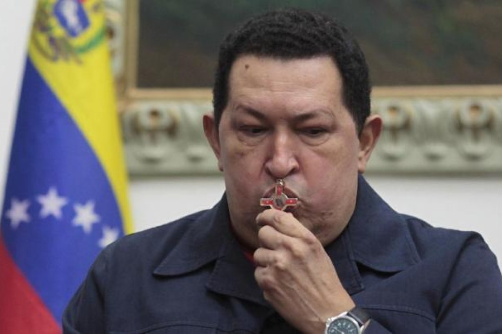Venezuelan President Hugo Chavez kisses a crucifix as he speaks during a national broadcast, in which he announced his cancer had returned, at the Miraflores Palace in Caracas on Saturday. Photo Reuters