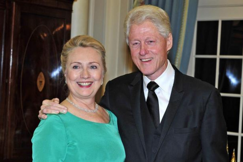Bill Clinton and wife Hillary pose for a photo in Washington. Photo: EPA