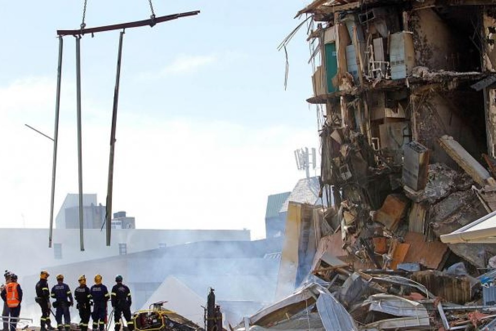 Rescuers survey the ruins of Christchurch's CTV building.