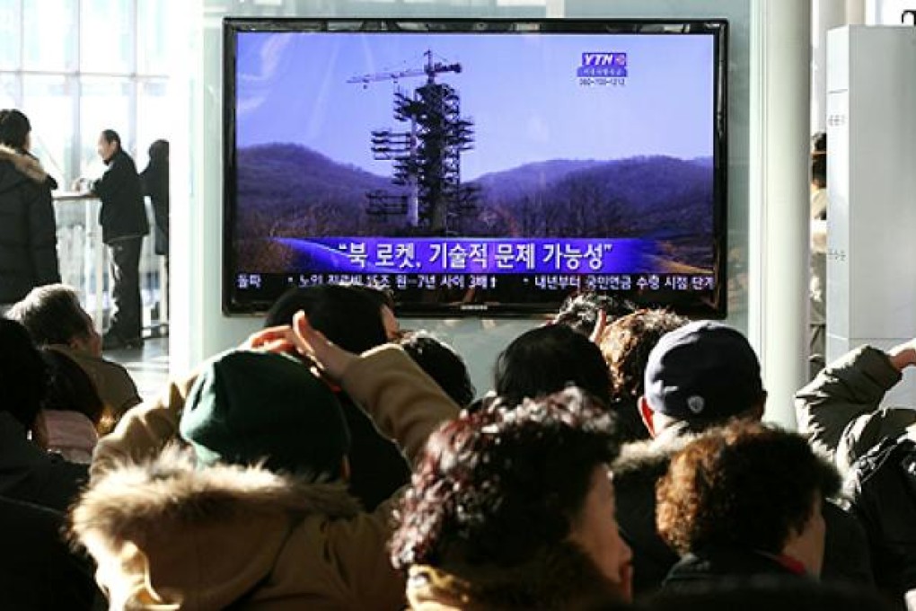 South Koreans watch the news about the North's rocket launch plans in Seoul on Sunday. Photo: AP