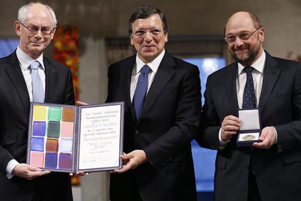 (Left to right) European Council President Herman Van Rompuy, European Commission President Jose Manuel Barroso, and European Parliament President Martin Schulz hold the Nobel diploma on the podium in Oslo City Hall. Photo EPA