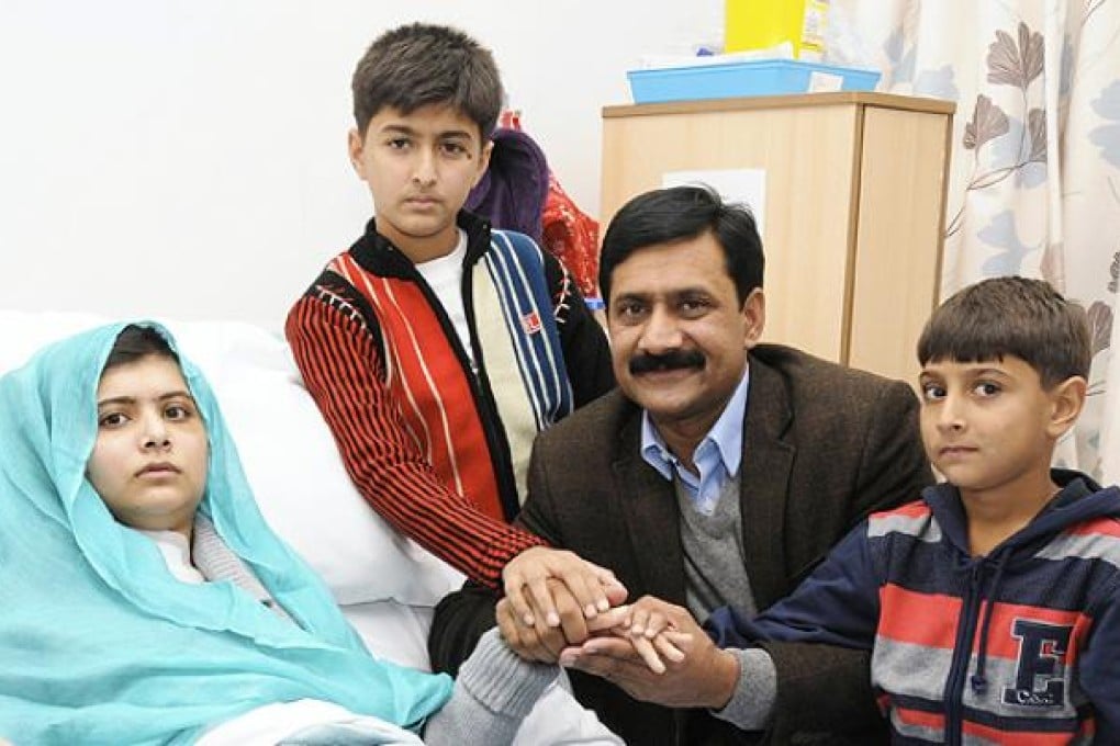 Ziauddin Yousafzai is seen with Malala and her two younger brothers Khushal Khan and Atal Khan (right) at The Queen Elizabeth Hospital in October. Photo: Reuters