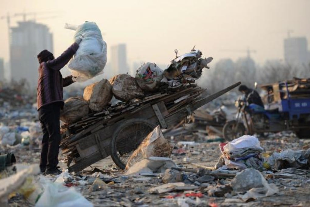 A female scavenger putting useful construction waste she picked up onto her trolly in a garbage dump in Hefei, central China's Anhui province. China's wealth gap has widened to a level where it is among the world's most unequal nations, a Chinese academic institute said in a survey, as huge numbers of poor are left behind by the economic boom. Photo: AFP