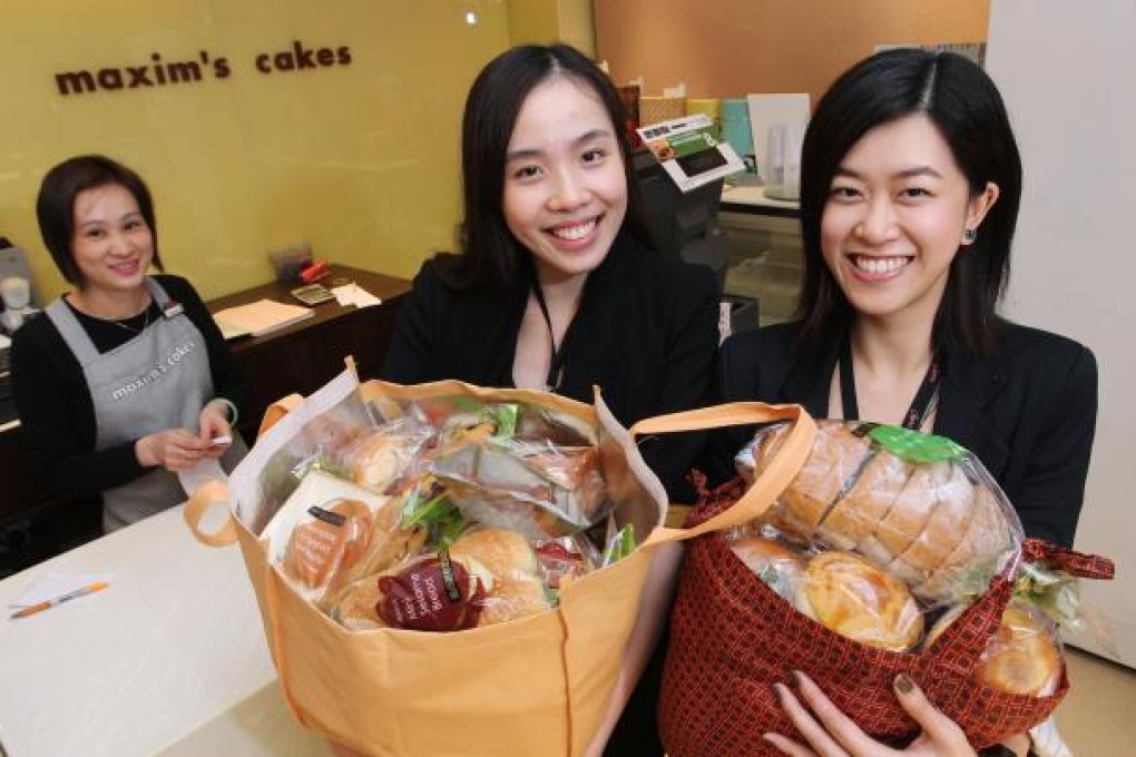 Maxim's Quarry Bay branch supervisor Joanna Hung (left) stands by as volunteers Margaret Lai (centre) and Karina Kwan collect surplus bread. Photo: May Tse
