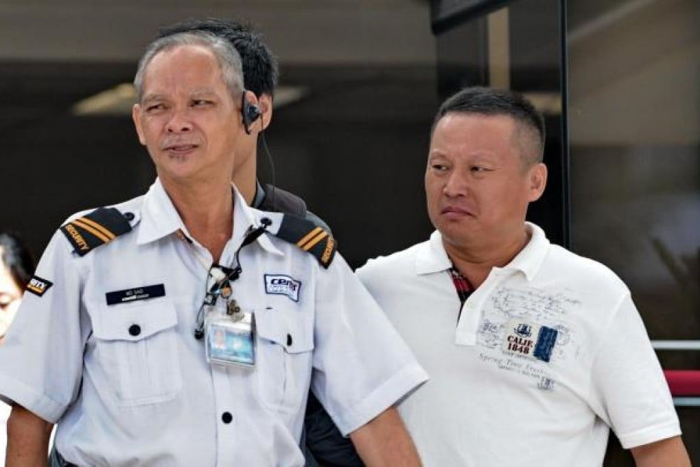 Wang Xianjie (right), one of four arrested Chinese bus drivers. Photo: AFP