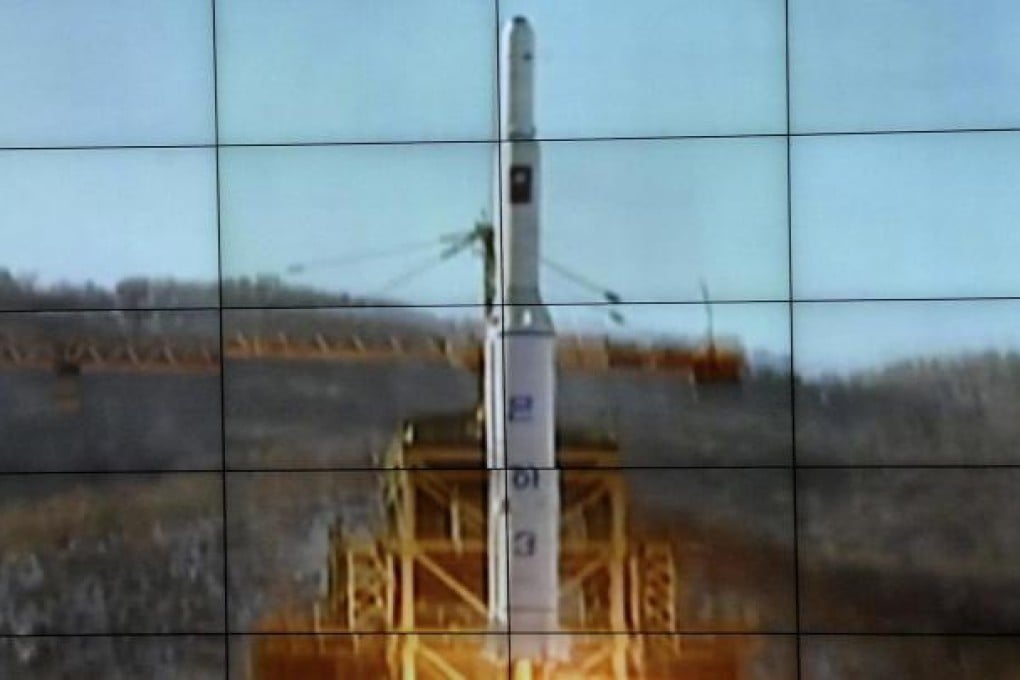 A screen shows the Unha-3 rocket taking off. Photo: Reuters