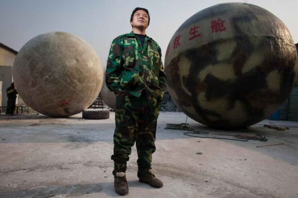 Furniture maker Liu Qiyuan, who has constructed spherical emergency shelters in a village in Langfang, Hebei, believes his structures could save his family from big floods, earthquakes or solar storms. Photo: AFP