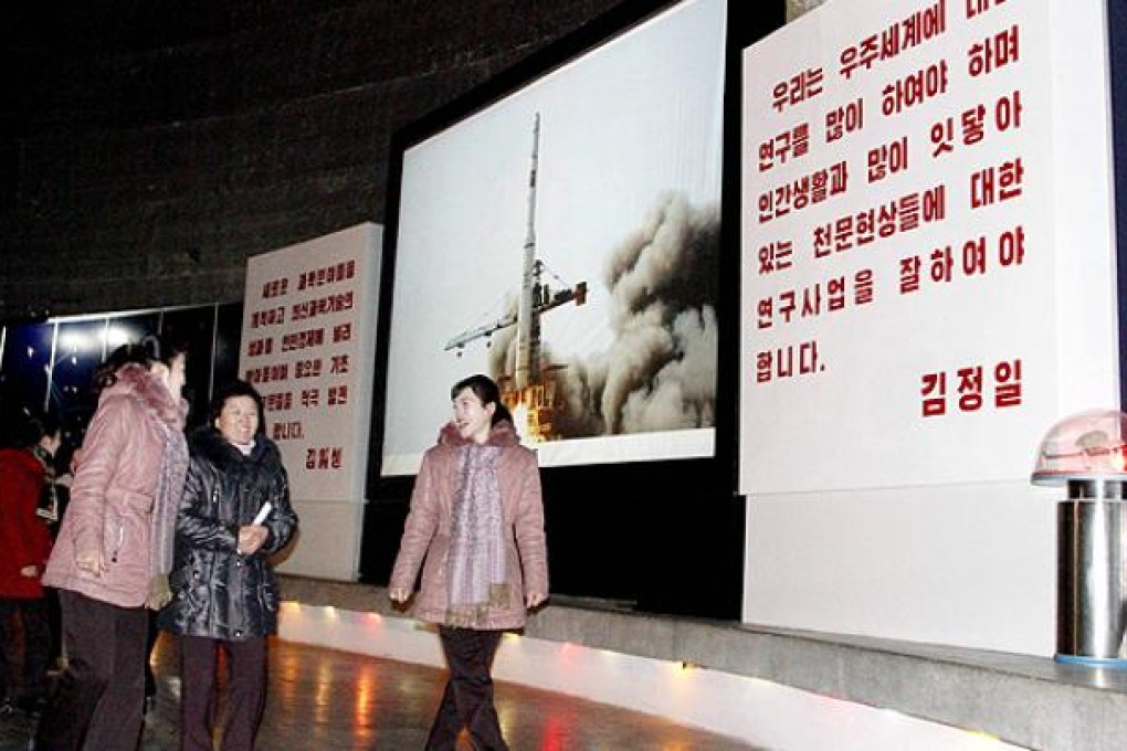 North Korean staff at the Three Revolution Exhibition Hall chat with one another inside the Satellite Hall after hearing the news of a rocket launch in Pyongyang. Photo: AP