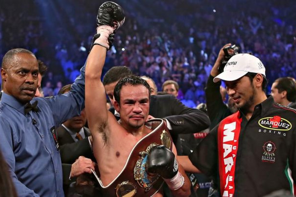 Juan Manuel Marquez raises his arm after defeating Manny Pacquiao. Photo: Xinhua