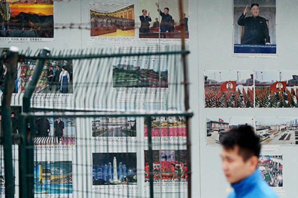 Photos of North Korean leader Kim Jong-un are plastered outside the North Korean embassy in Beijing. Photo: AFP