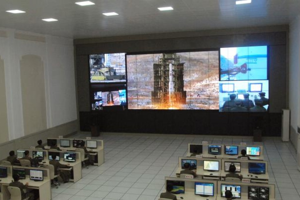 Scientists and technicians at the General Satellite Control and Command Center on the outskirts of Pyongyang watch the launch of the Unha-3 rocket. Photo: AP