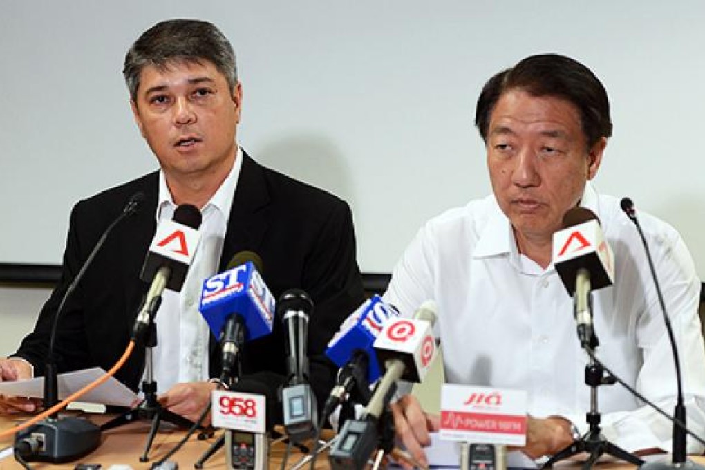 Singapore's Speaker of Parliament Michael Palmer (left) announces his resignation with Deputy Prime Minister Teo Chee Hean on Wednesday. Photo: AFP