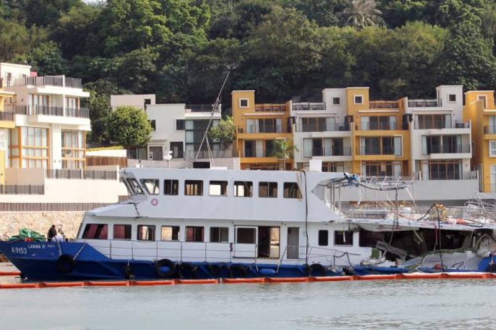 Police officers inspect the Lamma IV which sits docked at Nga Kau Wan. Photo: Edward Wong