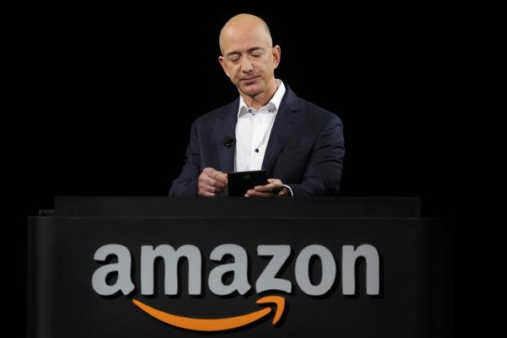 Amazon Chief Executive Officer Jeff Bezos demonstrates the Kindle Paperwhite during Amazon's Kindle Fire event in Santa Monica, California in this September 6, 2012 file picture. Photo: Reuters