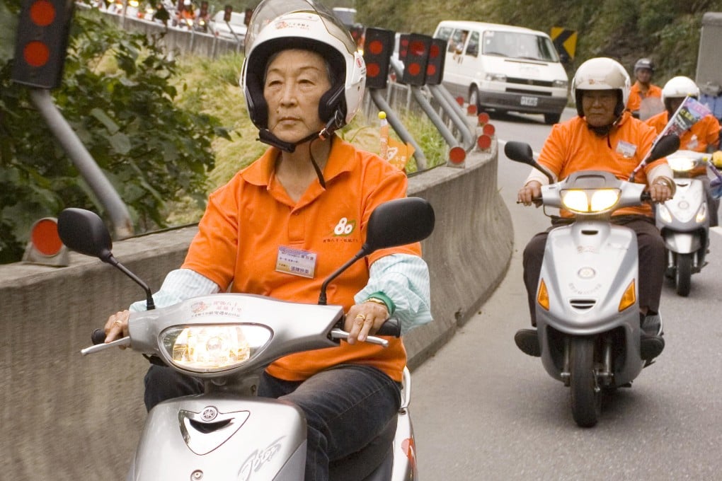 Zhang Cheng leads a procession of ageing scooter riders during the epic road trip across Taiwan. Photo: SCMP