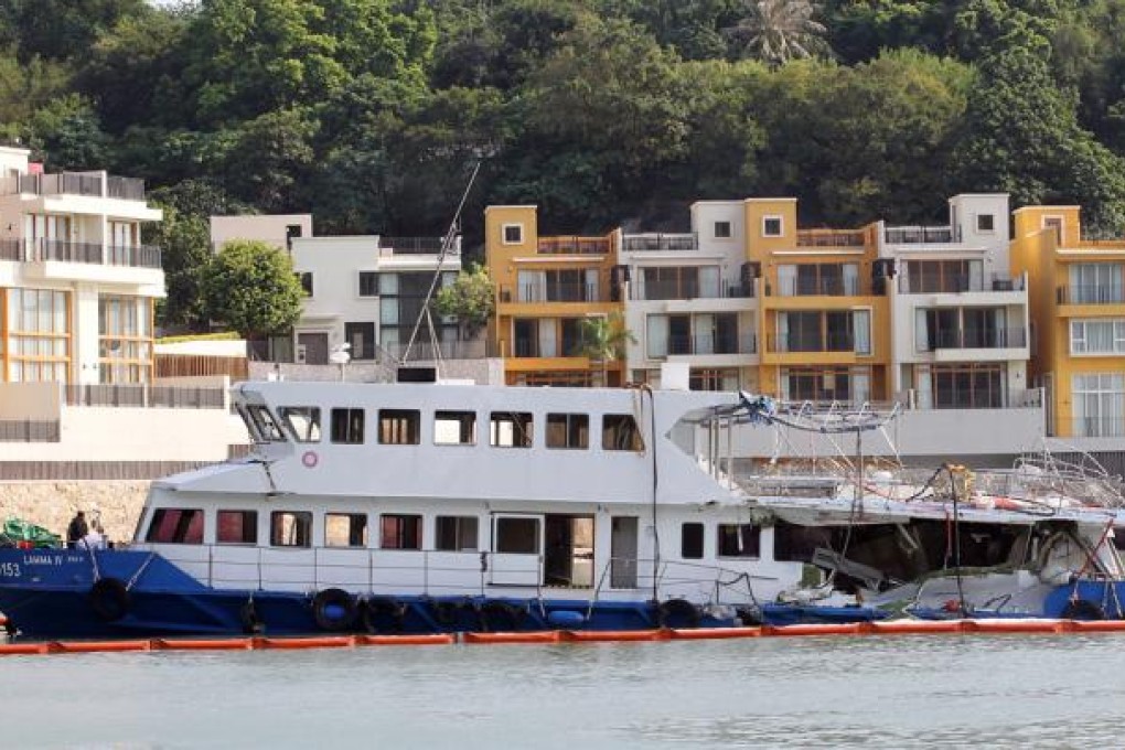 Police officers inspect the Lamma IV which sits docked at Nga Kau Wan. Photo: Edward Wong
