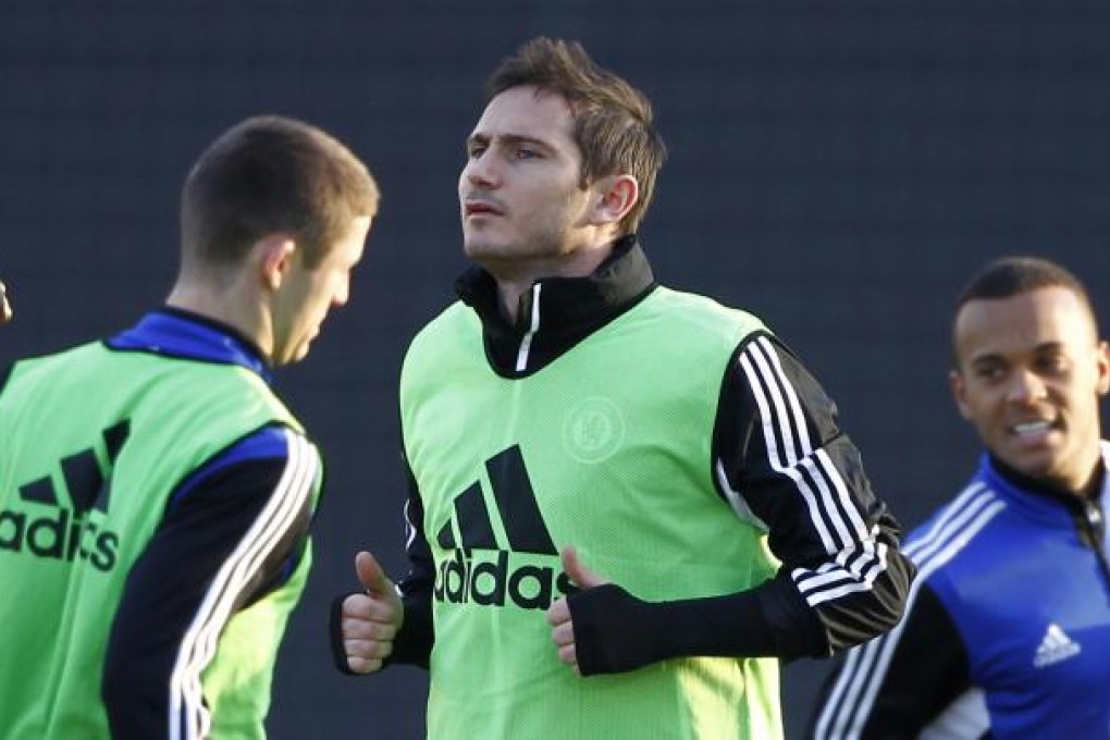 Chelsea's midfielder Frank Lampard, center, warms up during a training session for the FIFA Club World Cup soccer tournament in Yokohama.