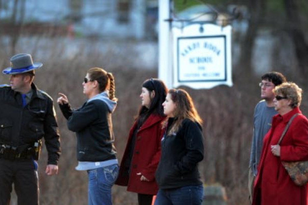 Family members of students of the Sandy Hook Elementary School get updated information from the police after the fatal school shooting in Newtown, Connecticut. Photo: Xinhua