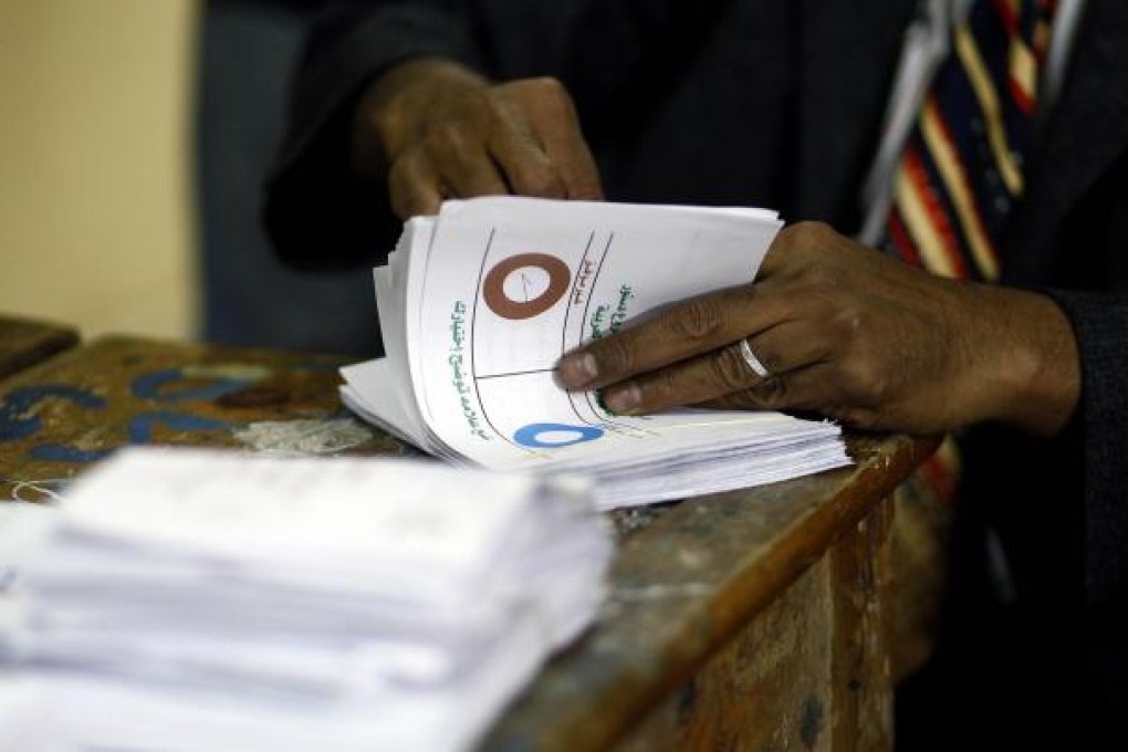 Officials count ballots at a Cairo polling station. Photo: AFP