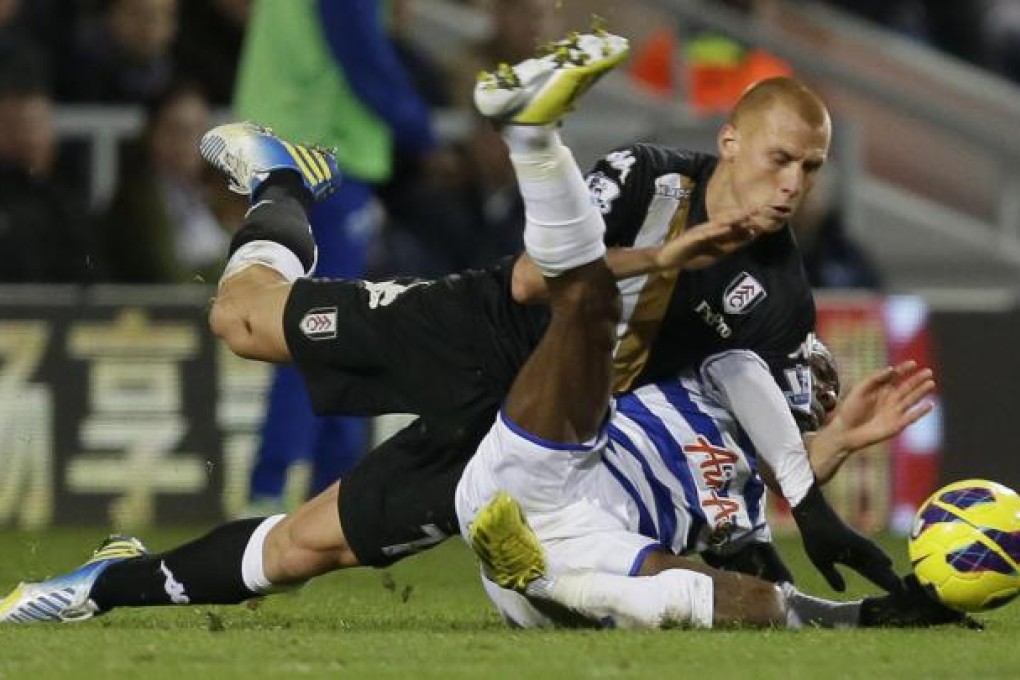 Queens Park Rangers winger Shaun Wright-Phillips (right) is tackled by Fulham's Steve Sidwell. Photo: AP