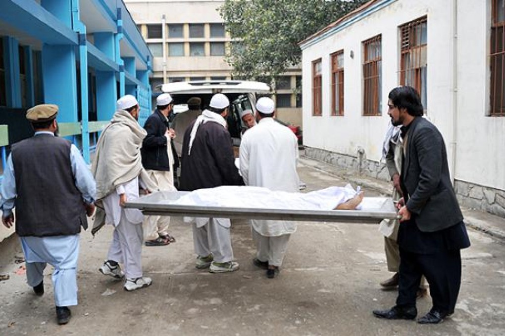 Afghan volunteers carry the body of one of the girls killed when a landmine exploded while they were collecting firewood to a vehicle in Jalalabad on Monday. Photo: AFP